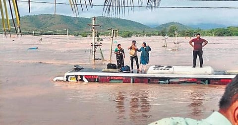 Passengers being rescued from a fully submerged RTC bus in flood water in Kadapa district on Friday. (Photo | Express)
