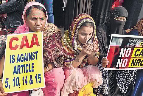 A Muslim woman prays in front of a Kolkata mosque during a protest against CAA and NRC. (File Photo | PTI)