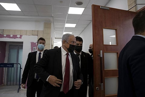 Former Israeli Prime Minister Benjamin Netanyahu, center, arrives to hear testimony by star witness Nir Hefetz, a former aide, in his corruption trial (Photo | AP)