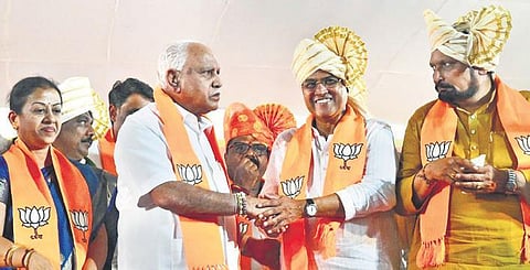 Senior BJP leader BS Yediyurappa greets party’s candidate for MLC polls from Belagavi Mahantesh Kavatagimath at ‘Jan Swaraj Yatra’ in Belagavi on Sunday, Nov 21, 2021. (Photo | EPS)
