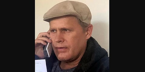 Joshua Spriestersbach talks on a phone in Danby, Vermont on March 2020. (Photo | AP)