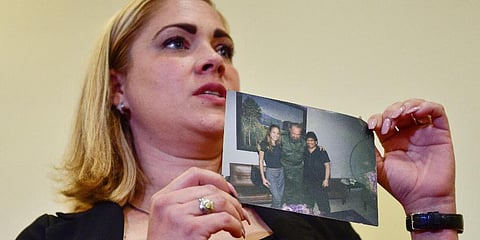 Mavys Alvarez shows a photograph of her with Diego Maradona and Fidel Castro in Havana, Cuba, at a press conference in Buenos Aires, Nov 22, 2021. (Photo | AP)
