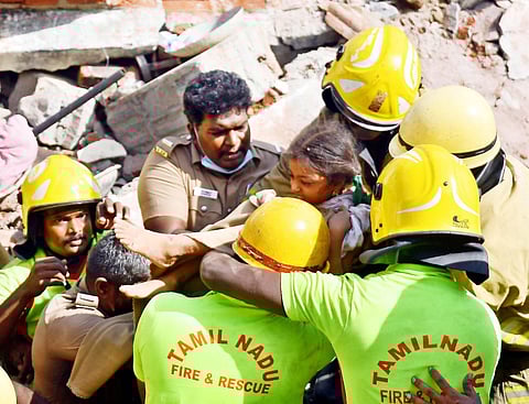 Fire fighters rescuing a girl at the site of a building collapse triggered by cylinder blast in Salem on Tuesday. (Photo I EPS)