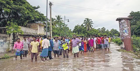 People look on as Sankarabarani river overflows at Ariyapalayam near Villianur thereby blocking Pondy- Villianur route in Puducherry | G Pattabi Raman