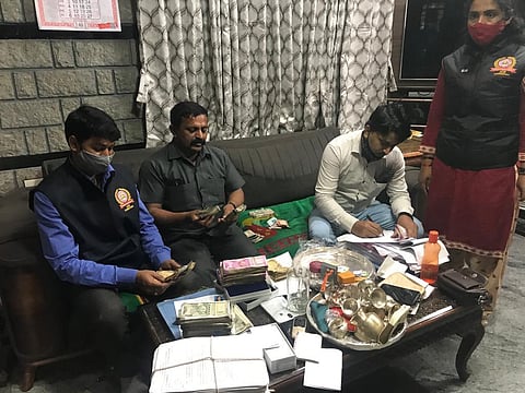 ACB officials take stock of the unearthed possessions at the residence of an agri dept officer in Karnataka. (Photo | Express)