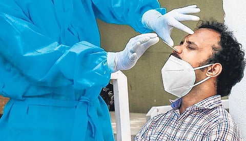 A man gives samples for RT-PCR test at a clinic in Bengaluru | express