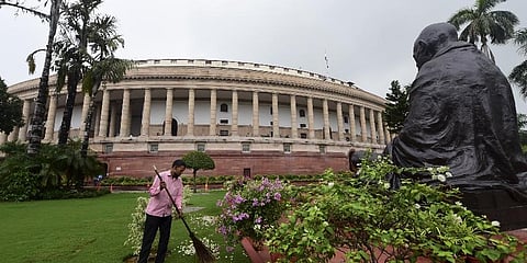 A worker cleans the Parliament complex in New Delhi. (Photo | PTI)