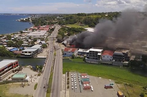 Smoke rises from burning buildings during a protest in the capital of Honiara, Solomon Islands (Photo | AP)