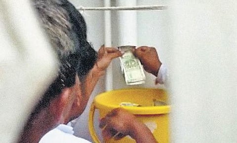 ACB sleuths pull out cash from a drain pipe at the house of a PWD junior engineer in Kalaburagi | Special Arrangement