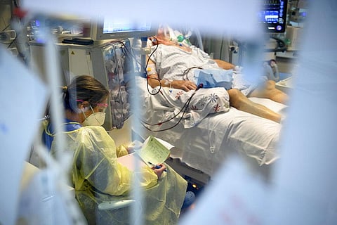 Medical worker treats a patient with Covid-19 in the intensive care unit at the hospital RHNe Pourtales site during the coronavirus disease (COVID-19) outbreak (Photo | AP)
