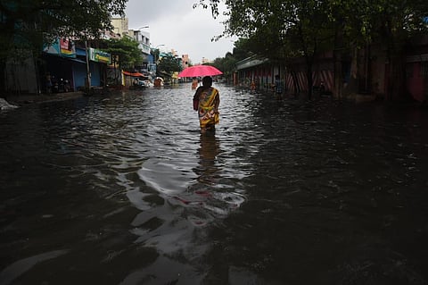 A woman wades through the stagnated rain water at K K Nagar in Chennai. (Photo | Ashwin Prasath, EPS)