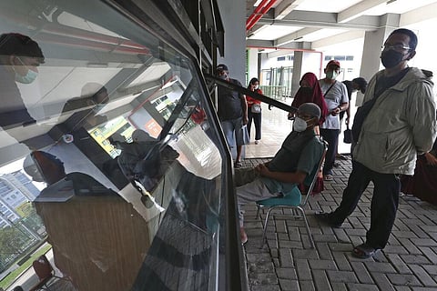 People register to receive a shot of COVID-19 vaccine during a vaccination campaign at the Patriot Candrabhaga Stadium in Bekasi on the outskirts of Jakarta. (Photo | AP)