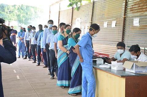 Students and staff of SDM Medical College in Dharwad queue up Covid19 test in college campus in Dharwad on Friday. (Photo | EPS)