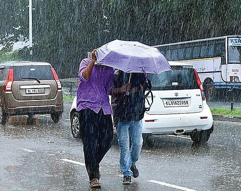 Two persons walk amid heavy rain at Thampanoor in Thiruvananthapuram. The district received a rainfall of 64 millimetres on Friday | B P Deepu