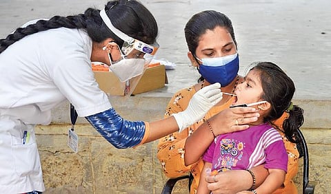 A child gives her throat samples for RTPCR test. (Photo | Vinod Kumar T, EPS)