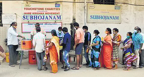 Volunteers distributing food as part of the Subhojanam initiative in KGH in Visakhapatnam. (Photo | G Satyanarayana, EPS)