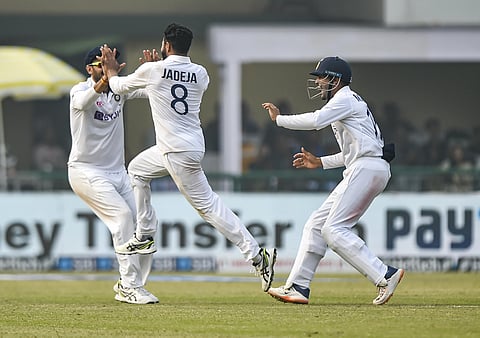 Indian player Ravindra Jadeja and his teammates celebrate the dismissal of New Zealand batsman Kane Williamson on fifth day of the first test cricket match between India and New Zealand. (Photo | PTI)