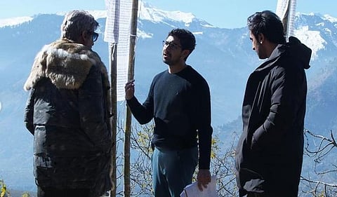 Ranbir Kapoor, Ayan Mukherji and Amitabh Bachchan can be seen talking to each other while standing against a scenic view. (Photo | Instagram)