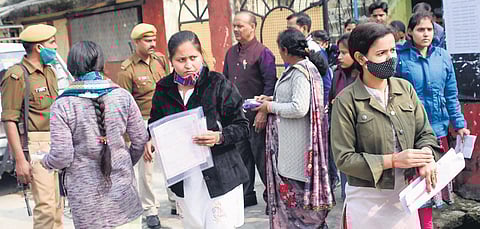Candidates wait outside an examination centre in Gorakhpur before the announcement on cancellation was made | pti