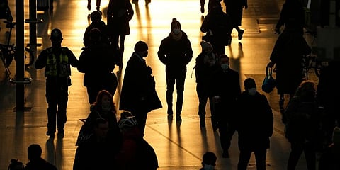 People pass through Waterloo train station, in London, during the morning rush hour. (Photo | AP)