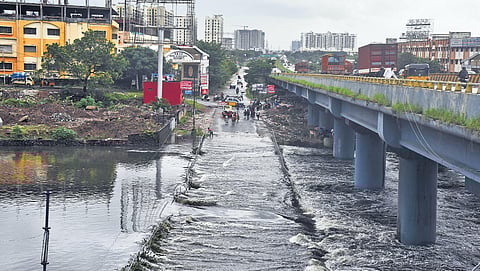 After the recent spell of rains, the Cooum flows over a Maduravoyal road in Chennai. (Photo| Martin Louis, EPS)