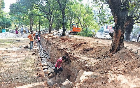 Works on construction of a new boundary wall in progress at Indira Park on Lower Tank Bund. (Photo | Express, S Senbagapandiyan)