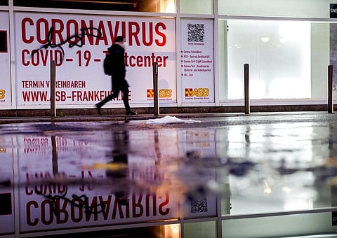 A woman walks past an abandoned coronavirus test center in Frankfurt. (Photo | AP)