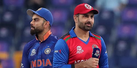 Afghanistan's captain Mohammad Nabi, right, smiles after winning the toss as India's captain Virat Kohli, left, looks on during their ICC T20 World Cup match in Abu Dhabi, Nov 3, 2021. (Photo | AP)
