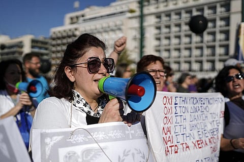 Healthcare workers opposing mandatory coronavirus vaccinations and the suspension from work for those who refuse to get the shots in Athens. (Photo | AP)