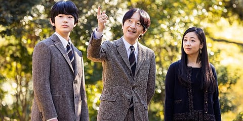 Japan's Crown Prince Akishino, center, strolls with his son Prince Hisahito and his daughter Princess Kako at the garden of their Akasaka imperial property residence in Tokyo. (Photo | AP)