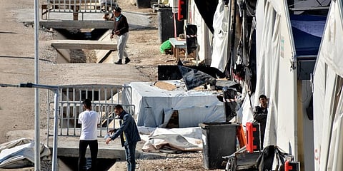 Migrants gather outside their tents at Karatepe refugee camp, on the northeastern Aegean island of Lesbos, Greece. (Photo | AP)
