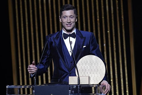Bayern Munich Robert Lewandowski holds the 2021 Ballon d'Or trophy for striker of the year during the 65th Ballon d'Or ceremony at Theatre du Chatelet, in Paris, Monday, Nov. 29, 2021. (Photo | AP)
