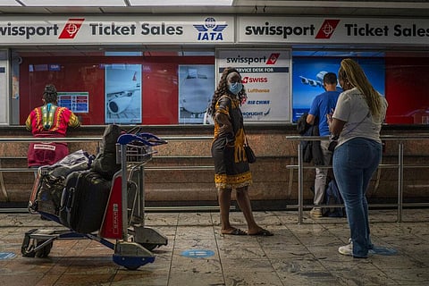 Passengers wait at a ticket counter at Johannesburg's OR Tambo's airport, Monday Nov. 29, 2021. (Photo | AP)