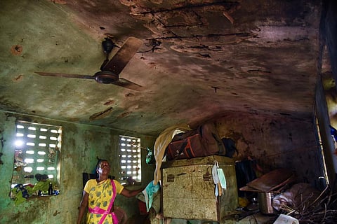 A woman staring at the roof of her dilapidated house at MGR Nagar at Arungundram village in Chengalpattu | Debadatta Mallick