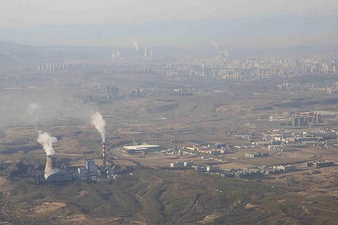 Smoke and steam rise from towers at the coal-fired Urumqi Thermal Power Plant in Urumqi in western China's Xinjiang Uyghur Autonomous Region. (Photo | AP)