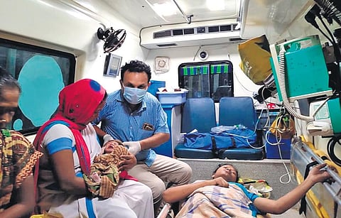 Emergency medical technician P Satyam and Asha worker Rajeswari with Savara Maheswari and her newborn son. (Photo| EPS)