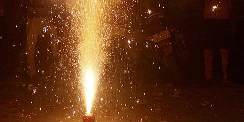People burn firecrackers on the occasion of Deepavali festival in Gurugram.