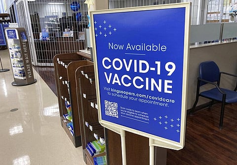 A sign notifies customers that COVID-19 vaccinations are available at a pharmacy in a grocery store in Monument, Colo. (Photo | AP)