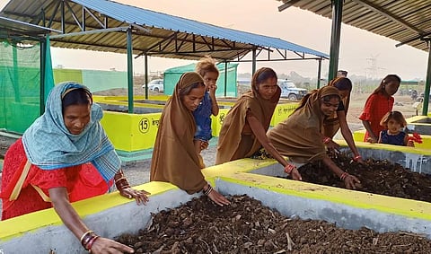 Women from Self-Help Groups work at Gauthan (cattle shed premises) used for representative purposes.