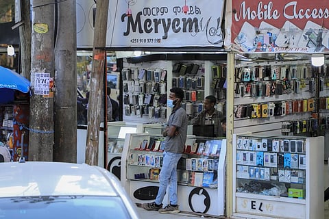 A man stands outside a mobile phone accessory shop in the Piazza old town area of the capital Addis Ababa, Ethiopia. (Photo I AP)