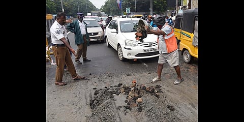 A pothole on the Poonamallee High Road at Kilpauk being filled with gravel and cement, in Chennai on Wednesday | R Satish Babu