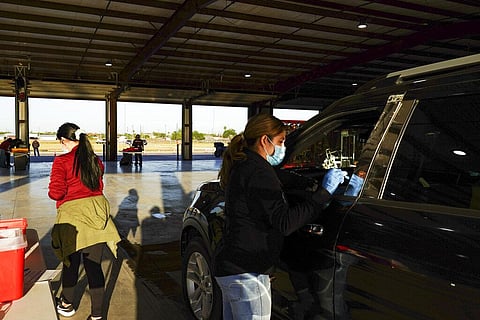 Medical assistant Jessica Martinez administers a Moderna booster shot to a resident at Cameron County Public Health's Moderna booster clinic. (Photo | AP)
