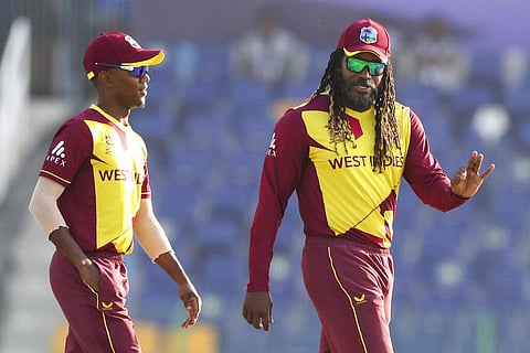 West Indies' Chris Gayle, right, gestures to teammate West Indies' Akeal Hosein. (Photo | AP)