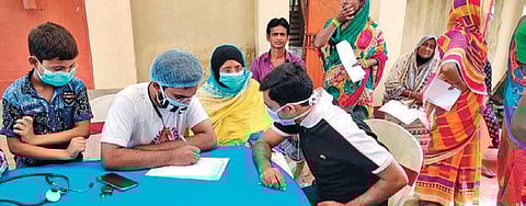 Dr Golam Ahmed Kibria (in white tee) with underprivileged patients.