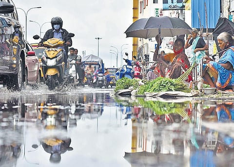 Motorists negotiating a waterlogged road in Aminjikarai on Saturday | P Jawahar