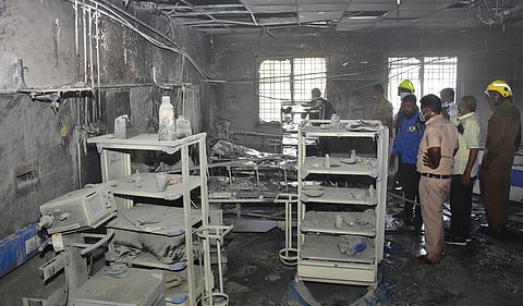 People inspect a hospital's COVID-19 ward that caught fire in Ahmednagar. (Photo | PTI)