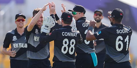 New Zealand's Adam Milne, second left, is congratulated by teammates after taking the wicket of Afghanistan's Mohammad Shahzad during the Twenty20 World Cup match in Abu Dhabi. (Photo | AP)