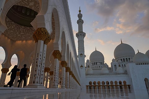 FILE - Tourists walk through Sheikh Zayed Grand Mosque at dusk in Abu Dhabi, United Arab Emirates, Wednesday, Dec. 9, 2020. (File photo | AP)