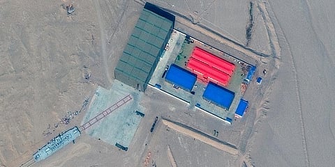 This satellite image provided by Maxar Technologies shows rail terminal and target storage building in Ruoqiang county, China. (Photo | AP)