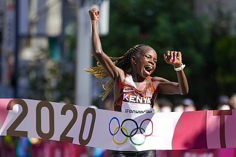 Peres Jepchirchir, of Kenya, celebrates as she crosses the finish line to win the women's marathon at the 2020 Summer Olympics. (File Photo | AP)